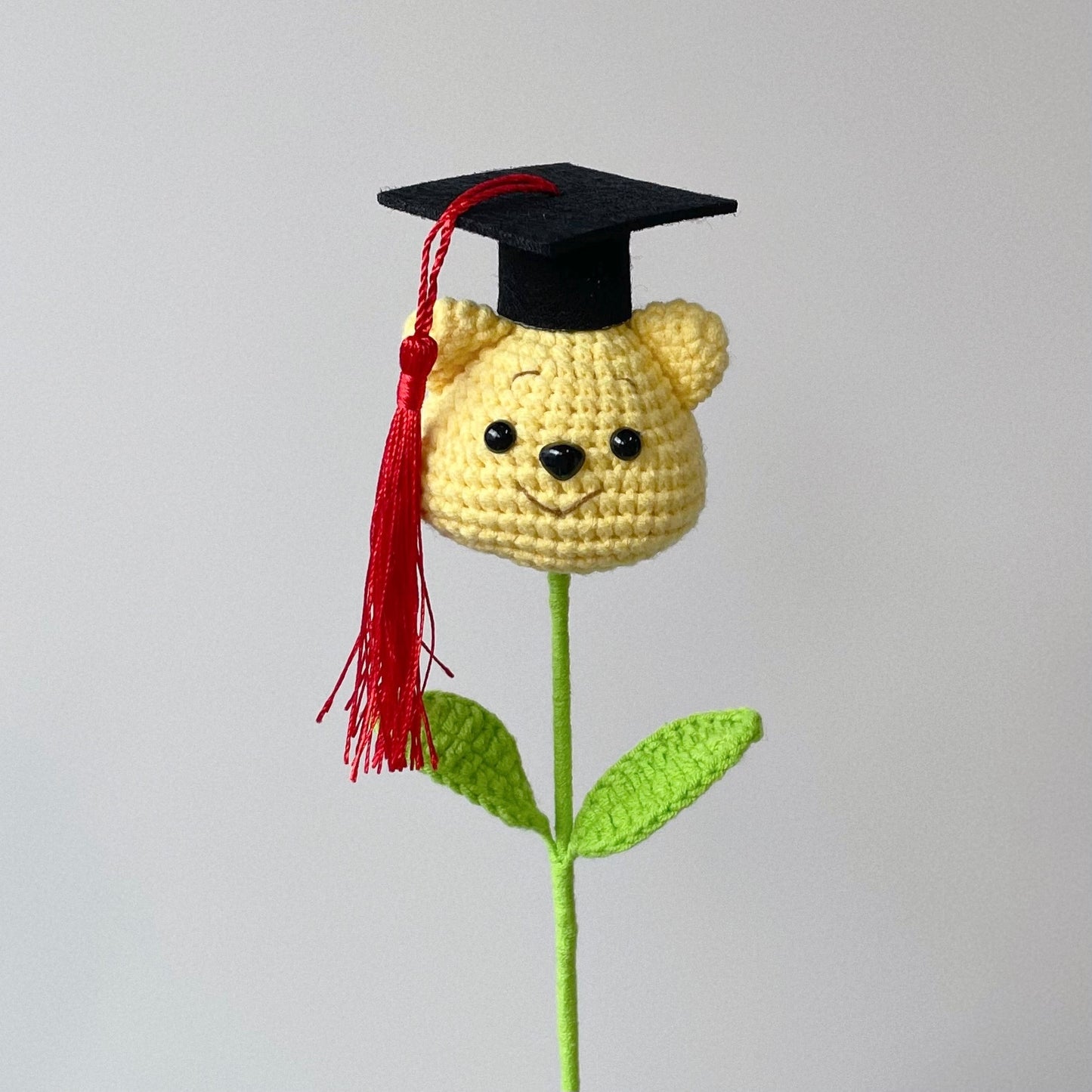 crochet cartoon character animal single stalk flower winnie the pooh with mortarboard